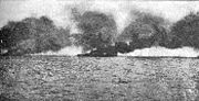 HMS Lion burning during the Battle of Jutland, after having been hit by a salvo from SMS L&uuml;tzow.