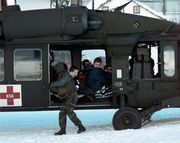 A Blackhawk helicopter as the crew prepares to evacuate tourists stranded by an avalanche in Galt&uuml;r, Austria, on February 25, 1999.