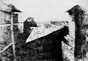 Nic&eacute;phore Ni&eacute;pce's earliest surviving photograph, c. 1826. This image required an eight-hour exposure, which resulted in sunlight being visible on both sides of the buildings.