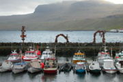 The harbor at Fuglafj&oslash;r&eth;ur, Faroe Islands shows seven typical Faroe boats used for fishing.