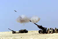 A 155&nbsp;mm M198 howitzer firing a shell.