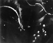 The Japanese aircraft carriers Zuikaku, left, and (probably) Zuihō come under attack by dive bombers early in the battle off Cape Enga&ntilde;o.