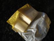 Palm oil block showing the lighter colour that results from boiling.