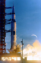 Apollo&nbsp;8 during launch, with a double exposure of the Moon, which was not visible during launch (NASA)