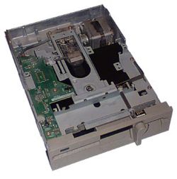 A user inserts the floppy disk, medium opening first, into a 5&frac14;-inch floppy disk drive (pictured, an internal model) and moves the lever down (by twisting on this model) to close the drive and engage the motor and heads with the disk.