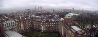 View of Belfast from The Ashby Building, part of QUB. The David Keir Building of Queen's University is in the foreground. The yellow fa&ccedil;ade of Belfast City Hospital is visible in the centre background, with the city's current tallest building Windsor House in the right background.